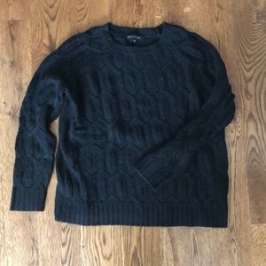 Black cable knit sweater with a geometric design